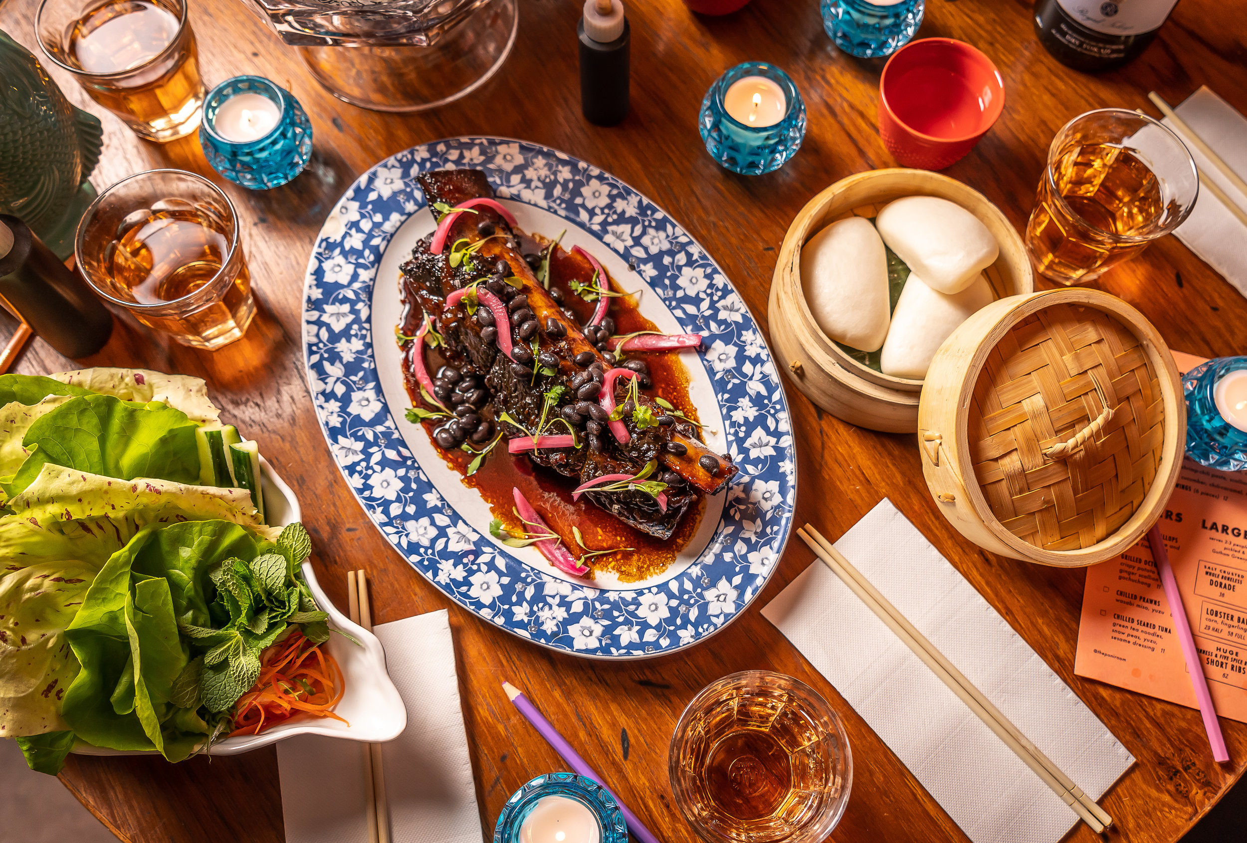braised ribs topped with black beans and red onions 